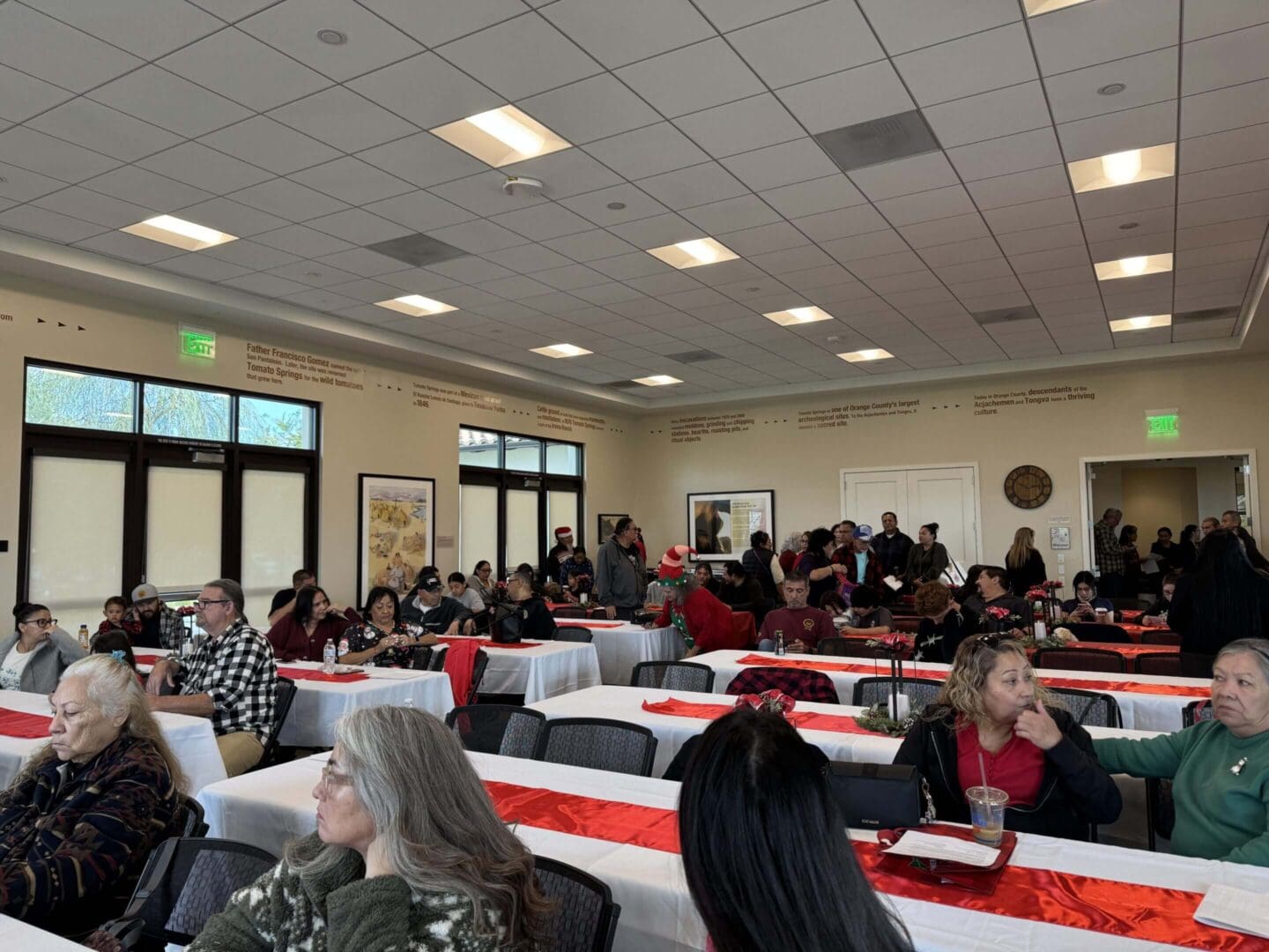 People gathered in a decorated community hall.
