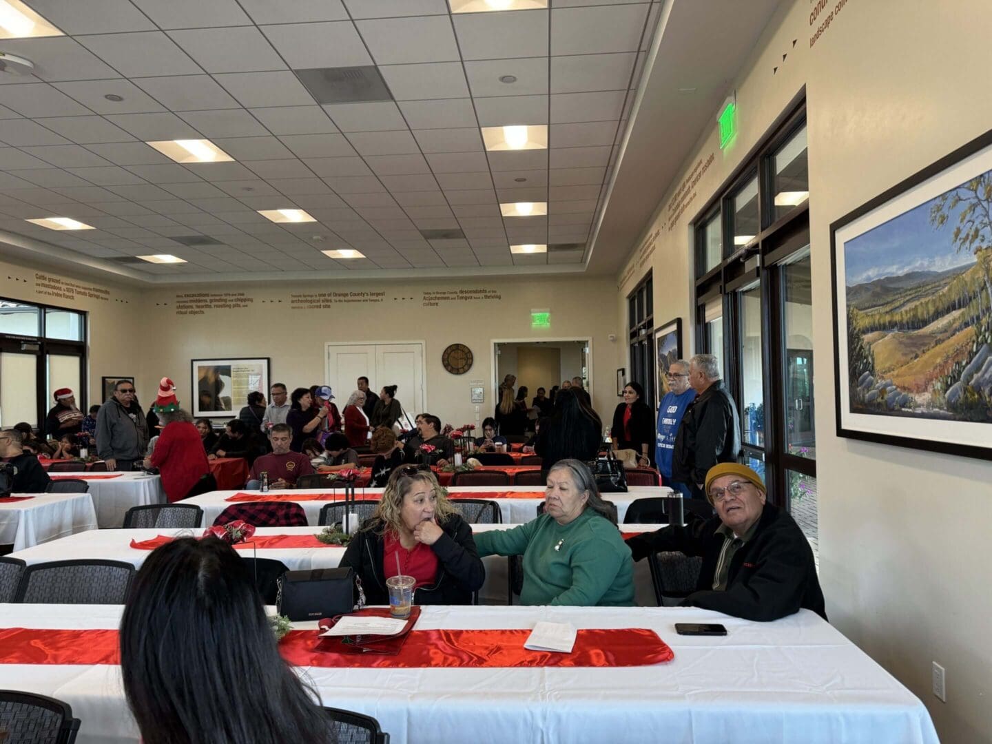 People gathered in a decorated community hall.