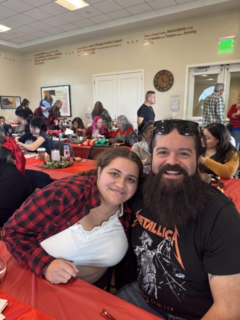 People smiling at a festive gathering event.