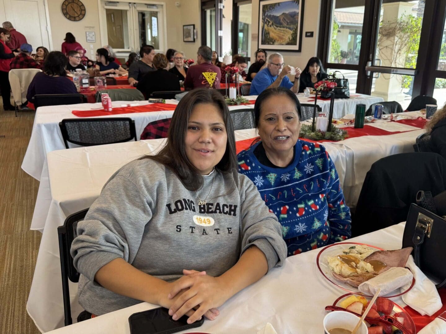 Two women sitting at a festive table.